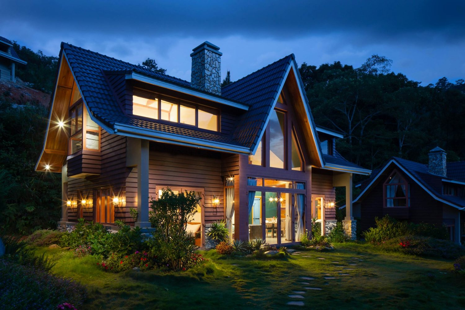 Custom house with a landscaped front yard at dusk